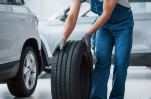 a mechanic holding a tire